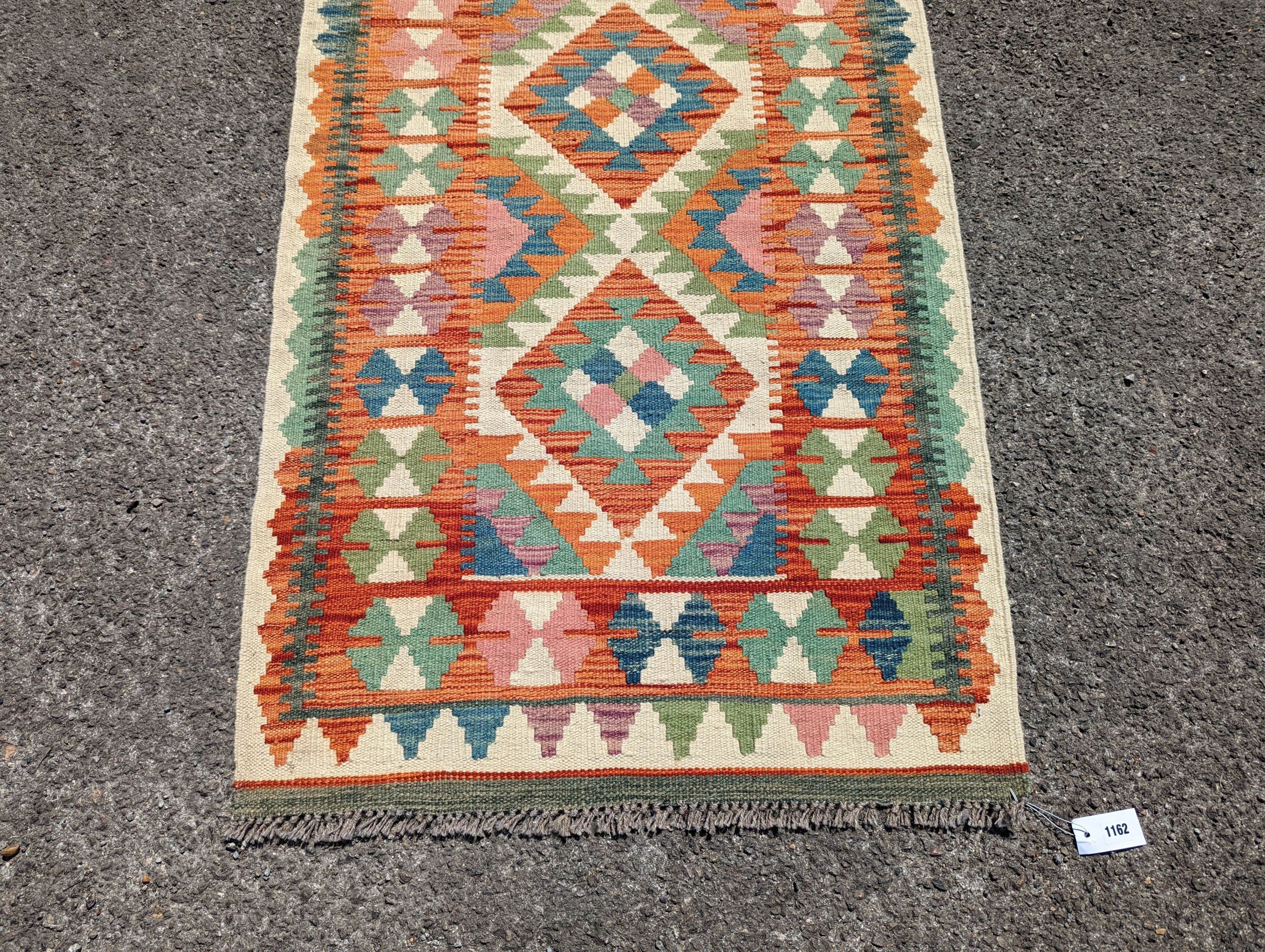 An Anatolian polychrome geometric flatweave Kilim runner, 290 x 84cm